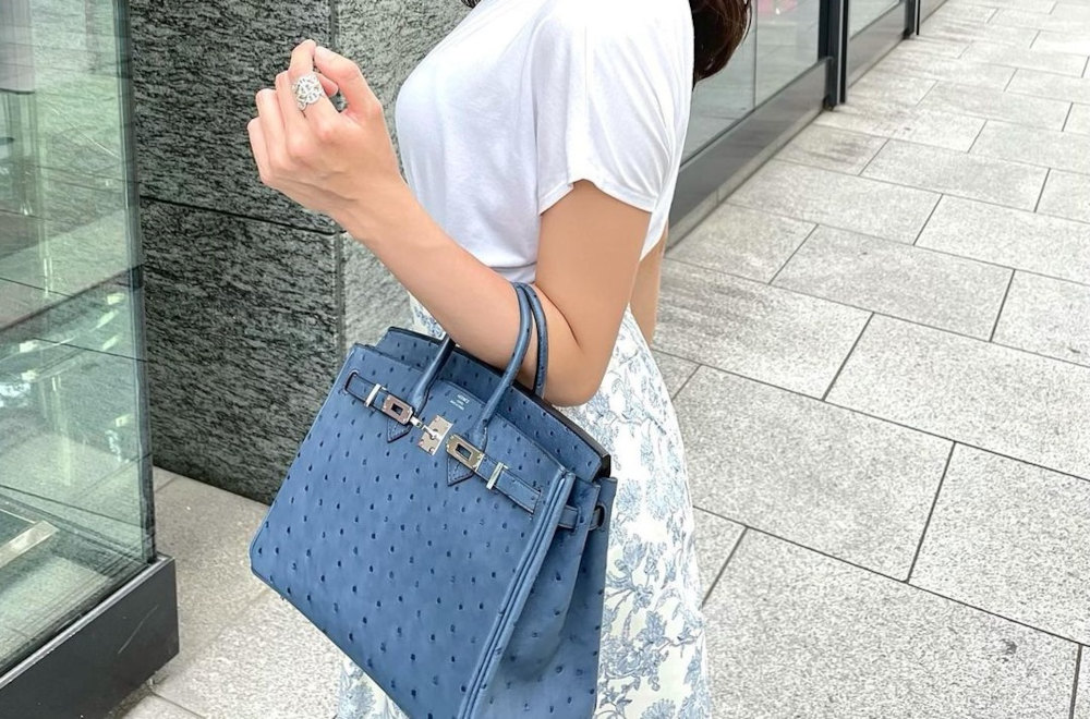 woman carrying a hermes birkin bag